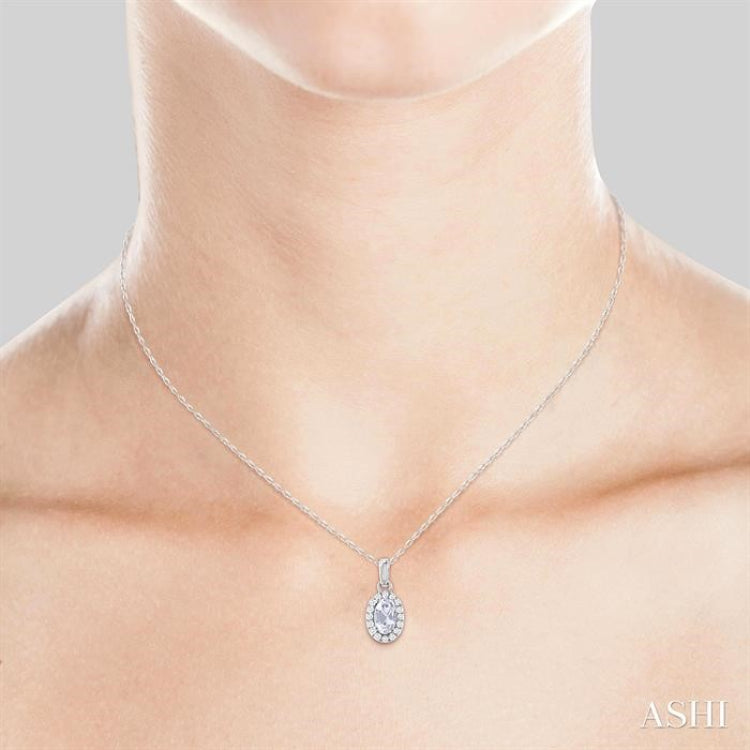 5x3 MM Oval Shape White Topaz and 1/20 Ctw Round Cut Diamond Halo Semi-Precious Pendant with Chain in 10K White Gold