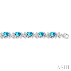 7x5 MM Oval Cut Blue Topaz and 1/10 Ctw Round Cut Diamond Semi-Precious Bracelet in Sterling Silver
